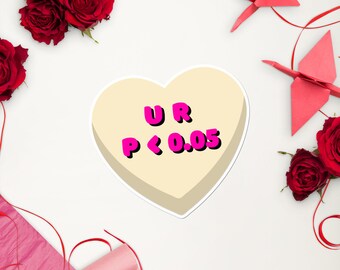 May include: A white heart-shaped candy with the text "UR P < 0.05" in pink letters. The candy is surrounded by red roses and origami paper.