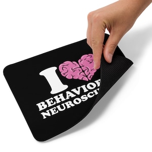 May include: Black mouse mat with a white "I love behavioural neuroscience" text and a pink brain-shaped heart.