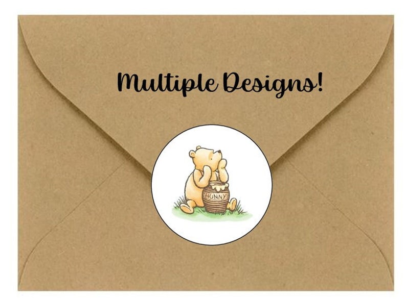 May include: A brown kraft paper envelope featuring a circular white sticker with a colored illustration of a yellow bear sitting next to a brown honey pot labeled HUNNY. The text Multiple Designs! is printed in black on the envelope flap.