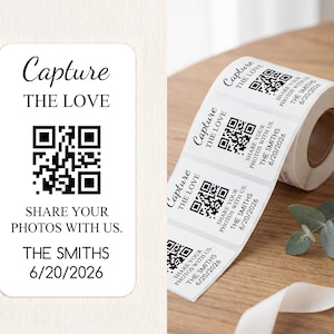 May include: A roll of rectangular white adhesive labels featuring a black QR code and the printed text Capture THE LOVE, SHARE YOUR PHOTOS WITH US, THE SMITHS, and the date 6/20/2026. The labels have rounded corners and a clean, minimalist design.
