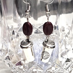 May include: A set of three ceramic mugs with a speckled, matte finish. The mugs are in shades of cream, light gray, and dark gray. Each mug has a simple, minimalist design, perfect for coffee or tea.