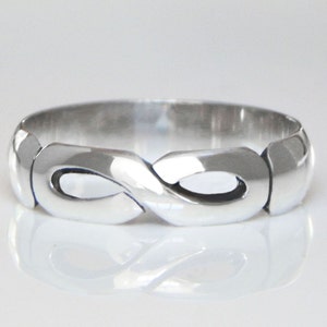 May include: A silver infinity ring with a smooth, polished finish.