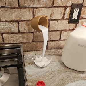 Floating milk cup mug sculpture kitchen decor pouring spilling coffee drink