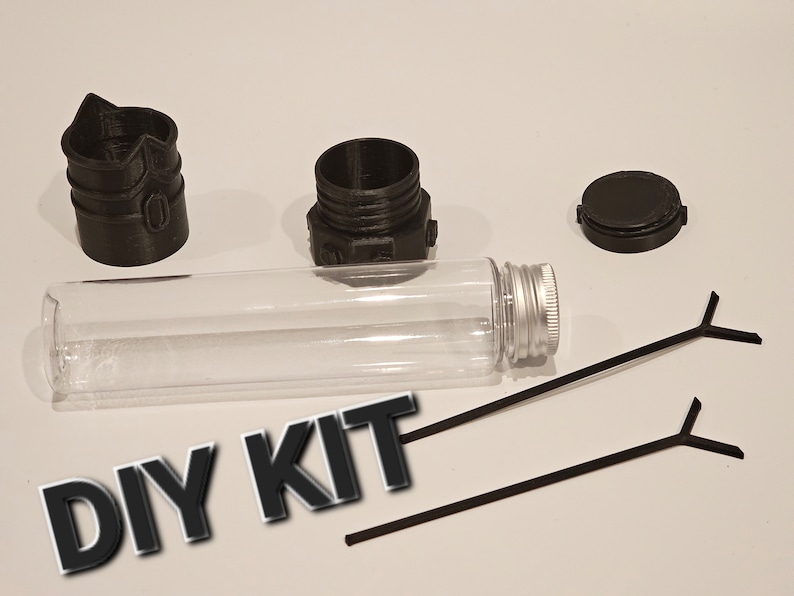 May include: DIY kit with a clear glass tube, two black plastic pieces, a silver lid, and two black plastic sticks. The text "DIY KIT" is written in black letters on a white background.