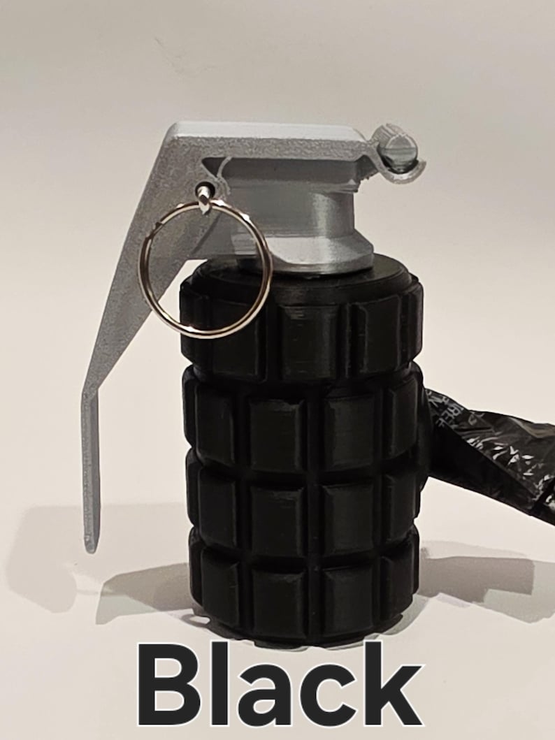 May include: A black novelty grenade with a silver-colored lever and pin. The body of the grenade is cylindrical with a textured surface. The word "Black" is printed in white at the bottom of the image.