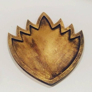 May include: A gold-colored, 3D printed, star-shaped pendant with a textured surface.