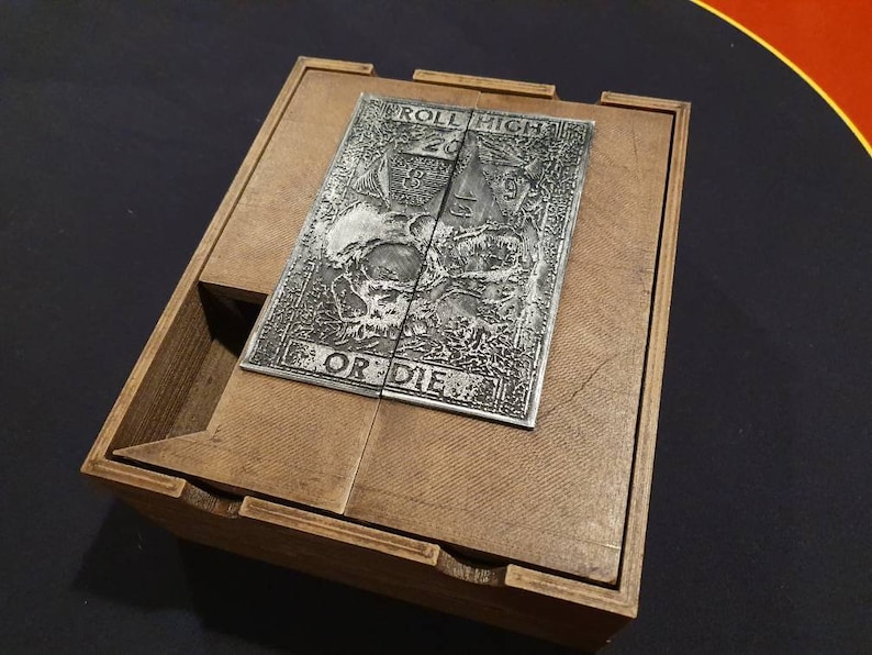 May include: A wooden box with a metal plate on the top. The plate has an engraved design with the words "Roll High or Die".