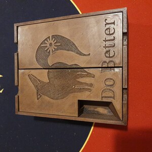 May include: A wooden box with a hinged lid. The box is engraved with a stylized fox and the words "Do Better".