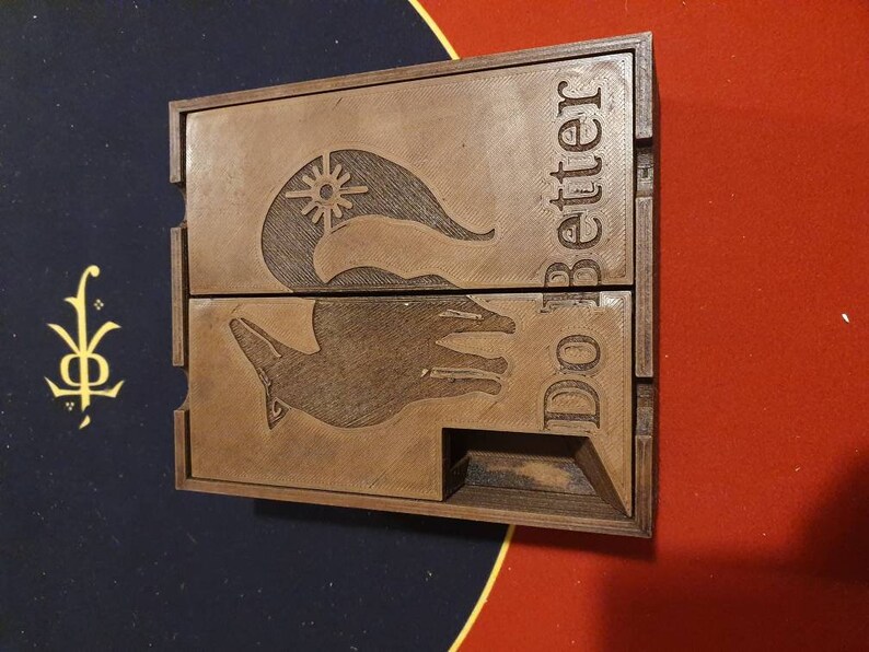 May include: A wooden box with a hinged lid. The box is engraved with a stylized fox and the words "Do Better".