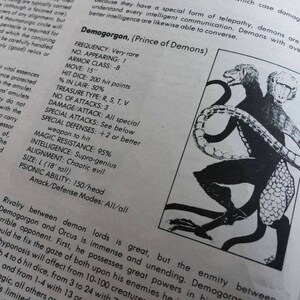 May include: Black and white illustration of a three-headed demon with a scaly tail. The demon is called Demogorgon, Prince of Demons. The text describes the demon's frequency, armor class, movement speed, hit dice, treasure type, number of attacks, damage per attack, special attacks, special defenses, magic resistance, intelligence, alignment, size, psionic ability, and attack/defense modes.