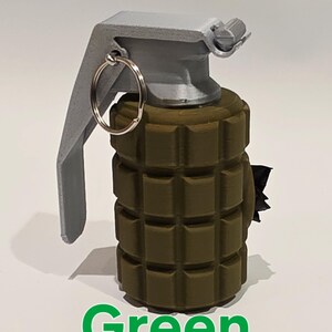 May include: A green grenade with a gray handle and a silver ring. The word "Green" is written in green at the bottom of the image. The grenade has a textured surface.