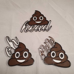 May include: Three brown poop emoji pins with white text. The text on the pins reads "Oh", "Head", and "Away".