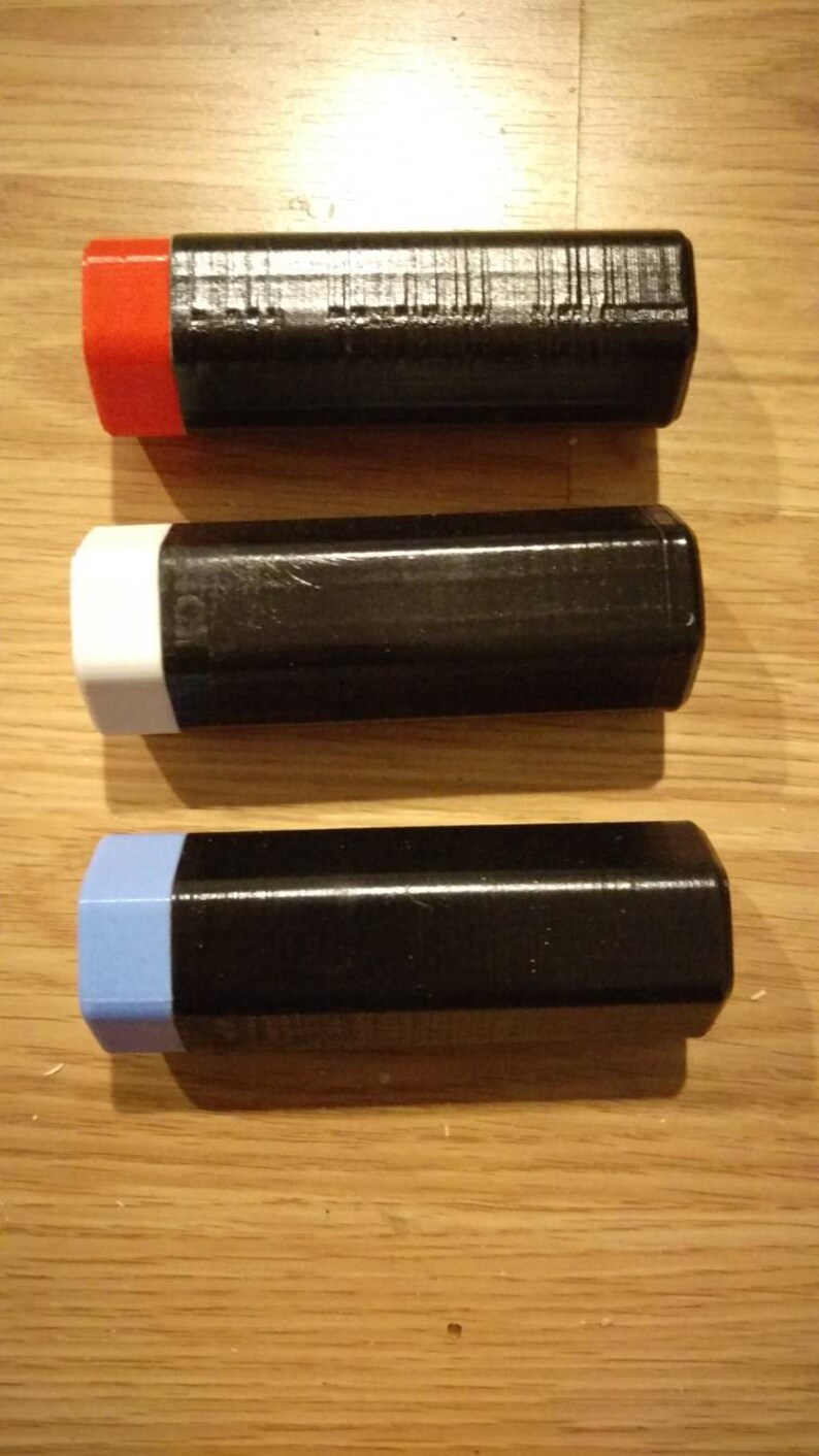 May include: Three black rectangular boxes with different colored edges. The top box has a red edge, the middle box has a white edge, and the bottom box has a light blue edge.