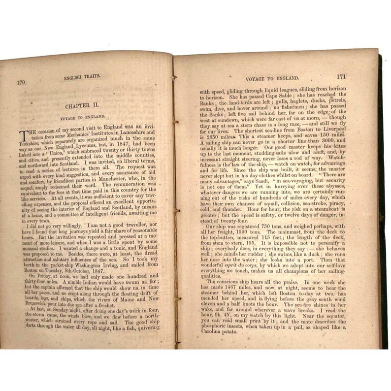 May include: A vintage book, titled "English Traits," open to a chapter on a voyage to England. The pages display aged text, with signs of wear, indicative of its age and use.