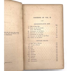 May include: Aged book pages displaying the "CONTENTS OF VOL II." with sections on "Representative Men" and "English Traits." The text is clearly visible, accompanied by page numbers, showing the book's contents.