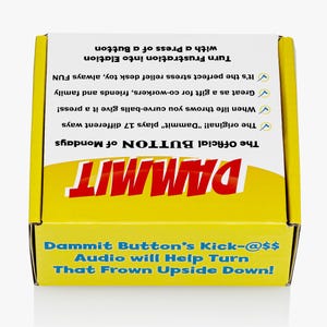 May include: A square yellow and white cardboard box featuring the text DAMMIT in large red letters. The box includes printed text describing the product as a button that plays 17 different sounds, intended for stress relief and as a gift.