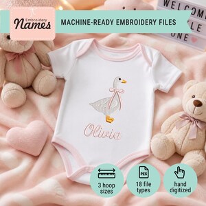 May include: A white baby bodysuit with short sleeves and light pink trim. The center features an embroidered design of a goose wearing a pink ribbon around its neck, with the name Olivia embroidered in pink script lettering below the goose.