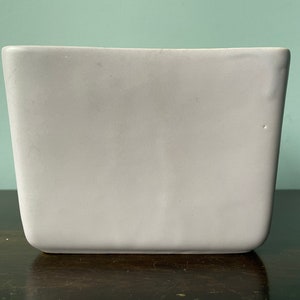 May include: A white ceramic rectangular planter with a smooth, matte finish.