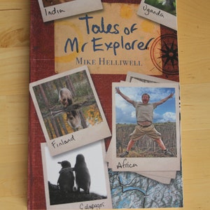 May include: A book cover with the title "Tales of Mr. Explorer" by Mike Helliwell. The cover features a collage of photos from different locations, including India, Uganda, Finland, Africa, and the Galapagos Islands.