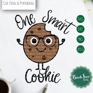 May include: A brown cookie with a bite taken out of it, wearing glasses and smiling. The cookie has arms and legs and is standing up. The text "One Smart Cookie" is written in black above the cookie. The text "Birch Tree SVG" is written in green below the cookie.