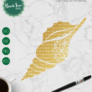 May include: A gold seashell with a white outline, featuring a repeating pattern of the words "Birch Tree SVG". The image is on a white marble background. The text "Commercial & Personal Use Designs" is at the bottom of the image.