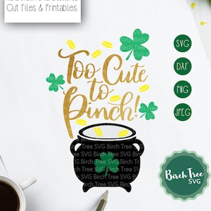 May include: A black and gold pot with gold coins spilling out of it. The text "Too Cute to Pinch!" is written in gold script above the pot. There are green shamrocks around the pot and text. The text "Birch Tree SVG" is in a green circle at the bottom right of the image.