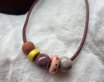 Leather necklace with handmade ceramic beads and gold luster accent