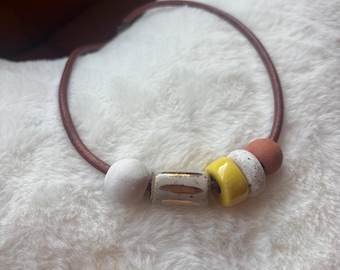 Leather necklace with handmade ceramic beads and gold luster accent