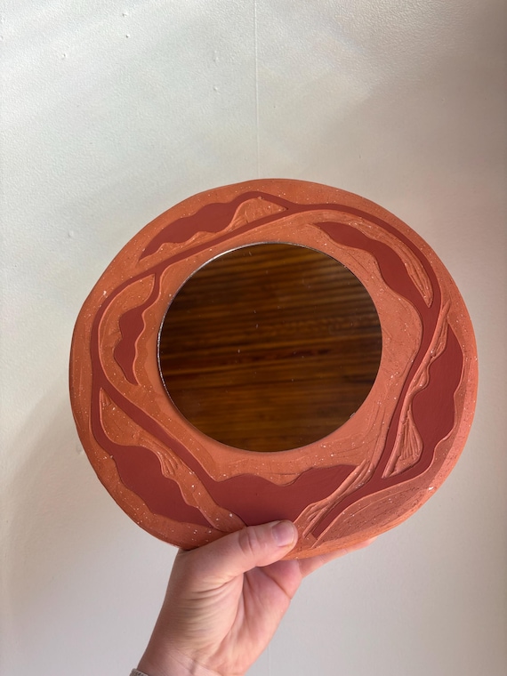 Leafy terra cotta mirror wall hang in red