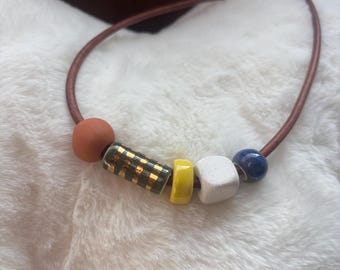 Leather necklace with handmade ceramic beads and gold luster accent
