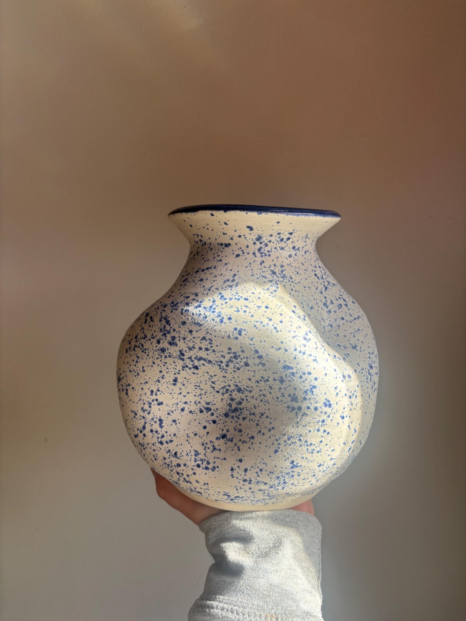 Large dented blue and white vase