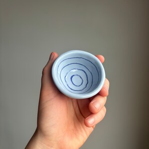 Tiny pinch pot dish with blue stripes