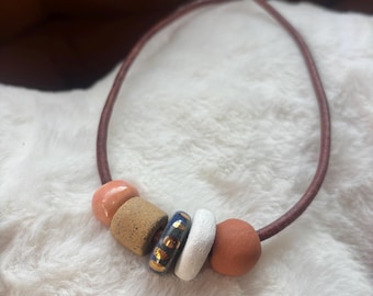 Leather necklace with handmade ceramic beads and gold luster accent