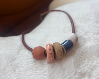 Leather necklace with handmade ceramic beads and gold luster accent