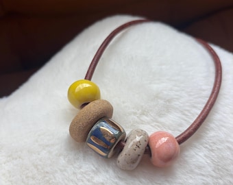 Leather necklace with handmade ceramic beads and gold luster accent