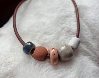 Leather necklace with handmade ceramic beads and gold luster accent