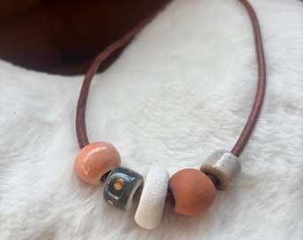 Leather necklace with handmade ceramic beads and gold luster accent