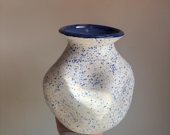 Large dented blue and white vase