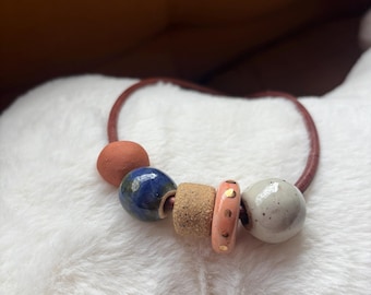 Leather necklace with handmade ceramic beads and gold luster accent