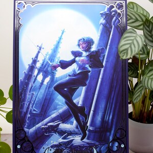 May include: A digital illustration of a person in a black and white outfit standing on a gargoyle in a gothic setting. The person is holding a sword and is looking to the left. The background is a blue and purple sky with a full moon. The image has a silver foil border and the text "Moonshine" at the bottom.