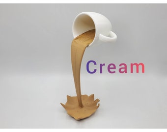 May include: A white ceramic cup pouring a stream of brown liquid into a brown ceramic base. The base is shaped like a puddle with a splash of liquid. The word "Cream" is written in a gradient of purple and red.