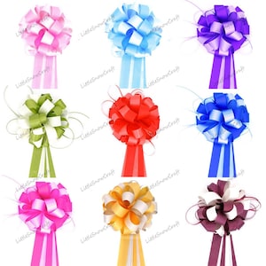 May include: Assortment of 10 large, decorative gift bows in various colours, including pink, blue, red, green, purple, gold, and burgundy. Each bow has a white centre and a long, matching ribbon tail.