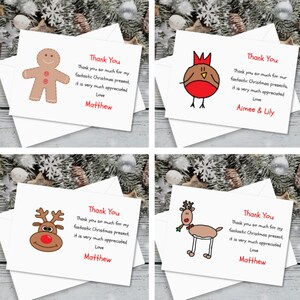 May include: Four thank you cards featuring different Christmas characters. The cards are white with black outlines and red accents. The characters are a gingerbread man, a robin, a reindeer, and a reindeer. The text on the cards reads "Thank You" and includes a message of thanks for a Christmas present. The cards are signed with names such as "Matthew" and "Aimee & Lily".