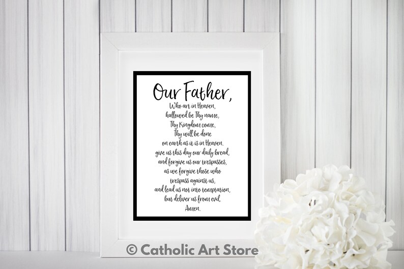 May include: A black and white printable wall art print with the text "Our Father, Who art in Heaven, hallowed be Thy name, Thy Kingdom come, Thy will be done on earth as it is in Heaven, give us this day our daily bread and forgive us our trespasses, as we forgive those who trespass against us, and lead us not into temptation, but deliver us from evil Amen." The print is framed in a white frame and has a black border.