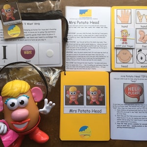 May include: A set of educational flashcards featuring Mrs Potato Head, a popular toy character. The cards are yellow with colourful illustrations and text. The cards include body parts, words, and a help sign.