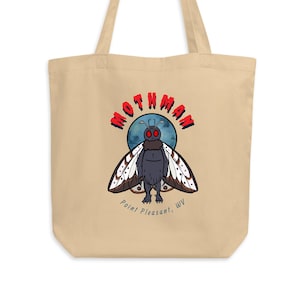 May include: A beige tote bag with a graphic of Mothman, a winged creature with red eyes, against a blue moon. The text "Mothman" is in red letters above the creature and "Point Pleasant, WV" is below.