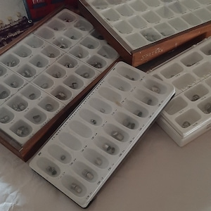 Vintage containers of dental bands, crowns and shade guides