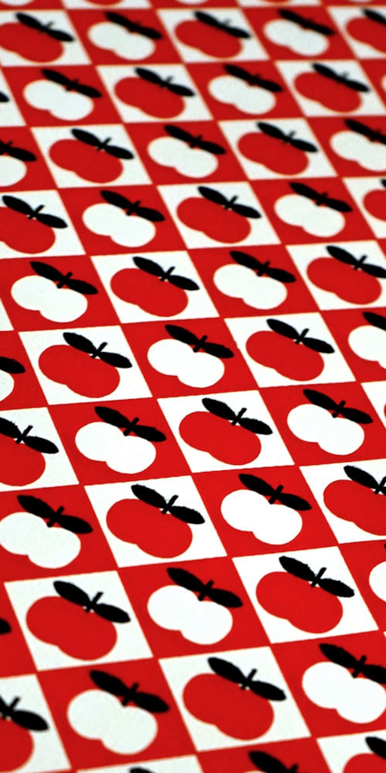 May include: A red and white checkered pattern with black apple silhouettes. The apples alternate between red and white.