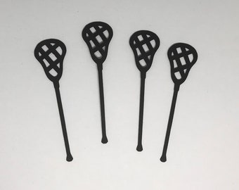 May include: Four black lacrosse sticks are displayed against a white backdrop. Each stick has a slender handle and a head with a woven net pattern. The sticks are uniformly spaced, with their heads pointing upwards.