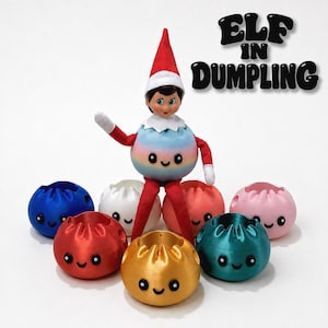 May include: A doll wearing a red hat and red sleeves sits atop a pastel rainbow-colored dumpling-shaped container. Surrounding it are seven additional dumpling-shaped containers in blue, white, red, gold, teal, pink, and orange. Text reads ELF IN DUMPLING.